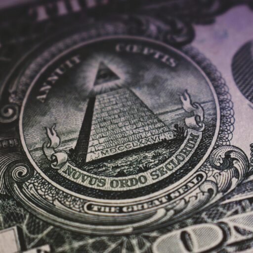 Detailed close-up of US dollar bill showing the Eye of Providence and pyramid design.